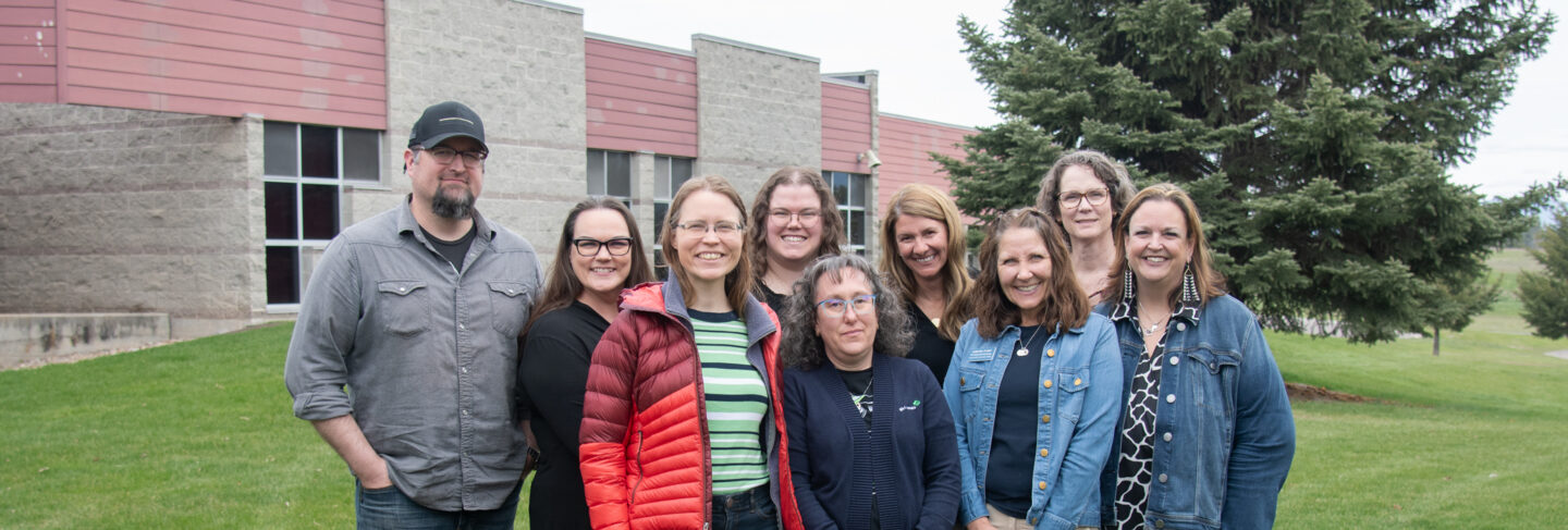 Group of faculty and staff at Flathead Valley Community College standing together outdoors.