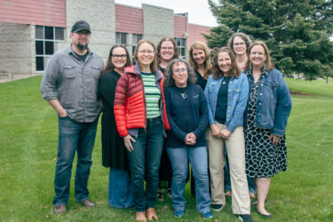 Group of faculty and staff at Flathead Valley Community College standing together outdoors.