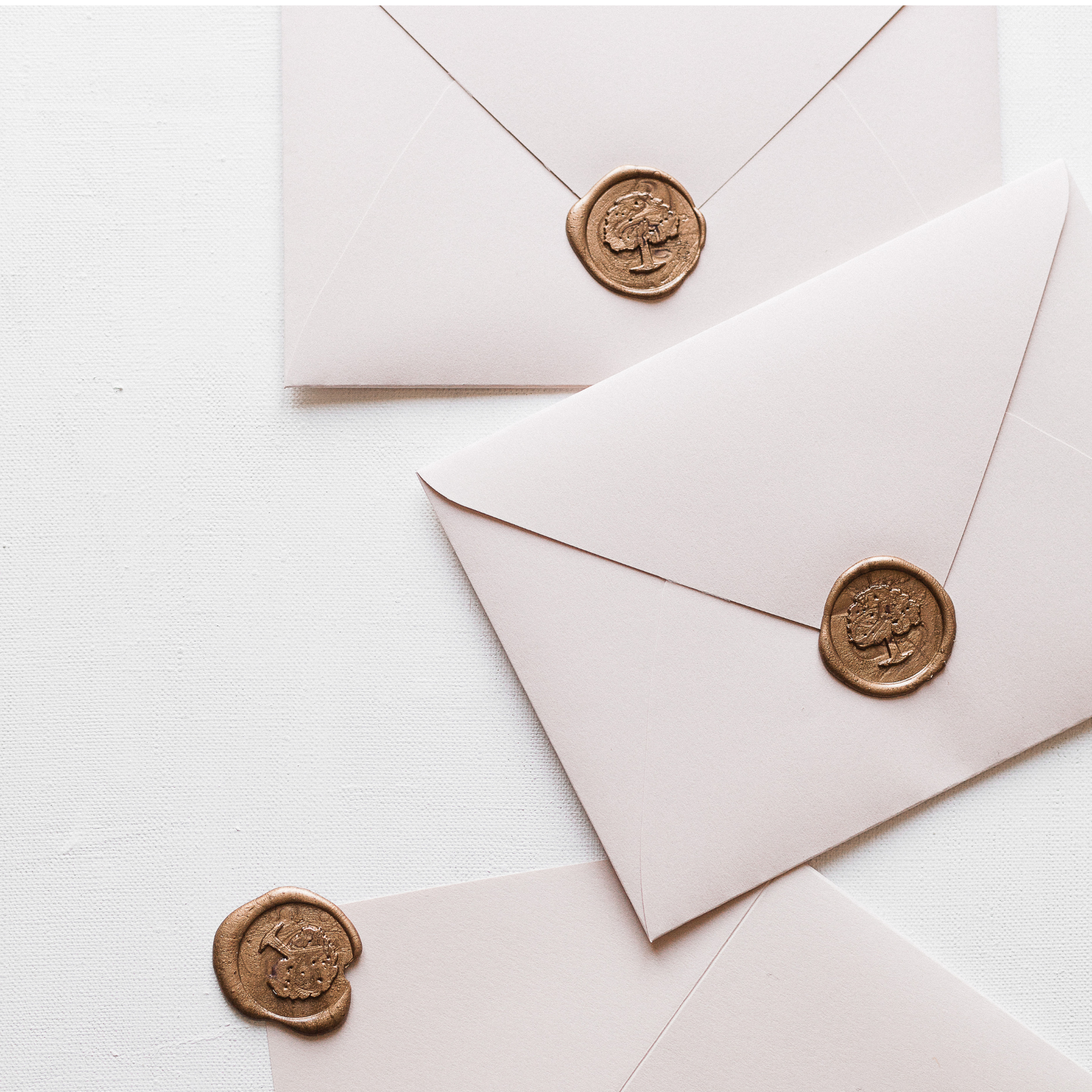 White envelopes with gold seals on them