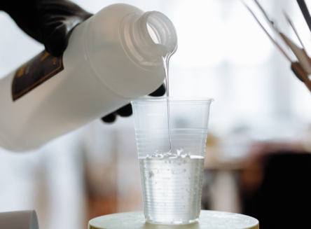 Resin mixture being poured into clear cup