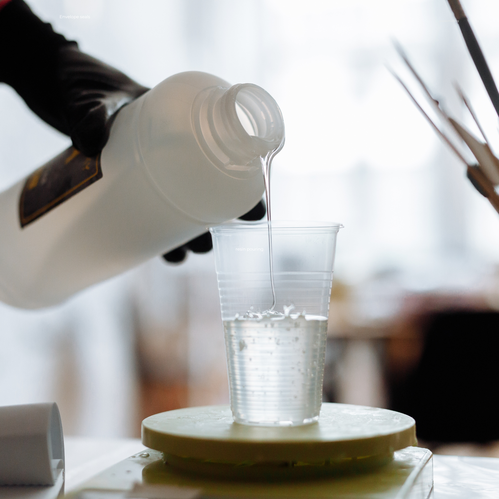 Resin mixture being poured into clear cup