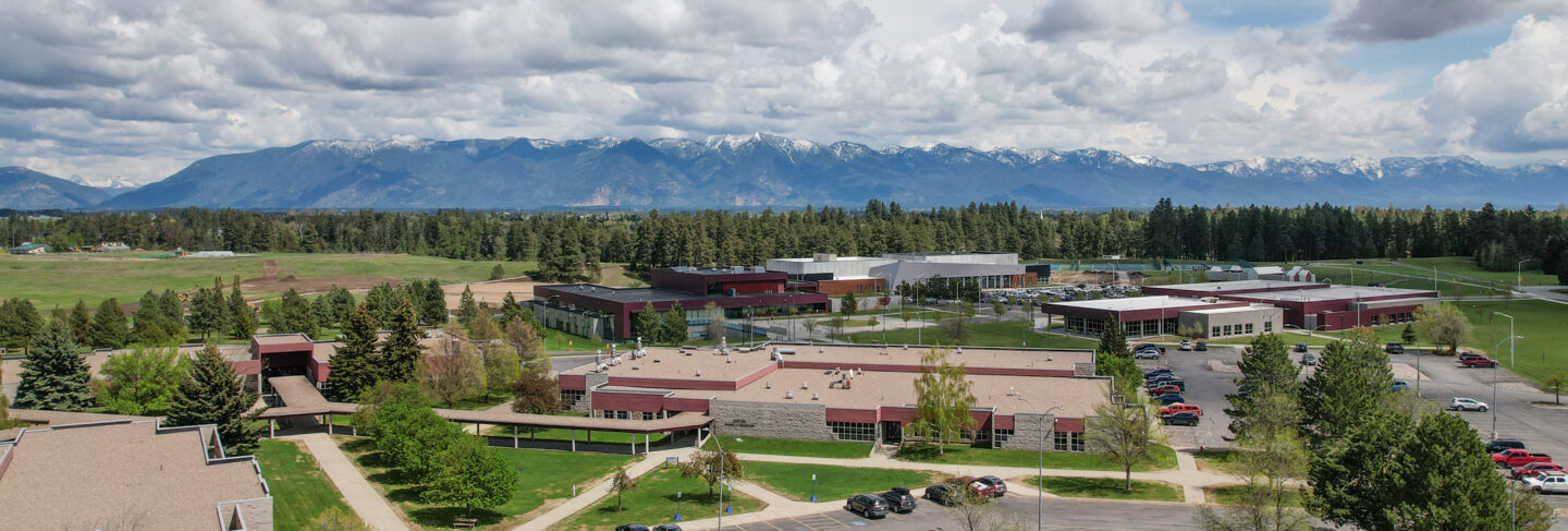 Aerial view of the Flathead Valley Community College campus with surrounding landscape and mountains.