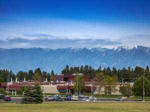 ground level photo of FVCC campus with mountains in background and tall wide blue sky