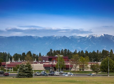 ground level photo of FVCC campus with mountains in background and tall wide blue sky