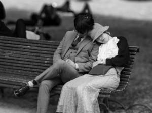 Paris couple sitting on park bench