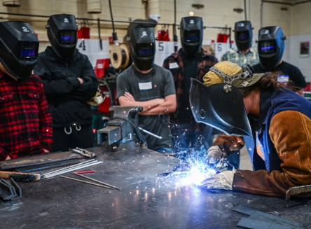 Flathead Valley Community College instructor Julie Arnold shows a group of prospective students different welding techniques during the college's Night of the Trades open house on Thursday, Oct. 3. (Casey Kreider/Daily Inter Lake)