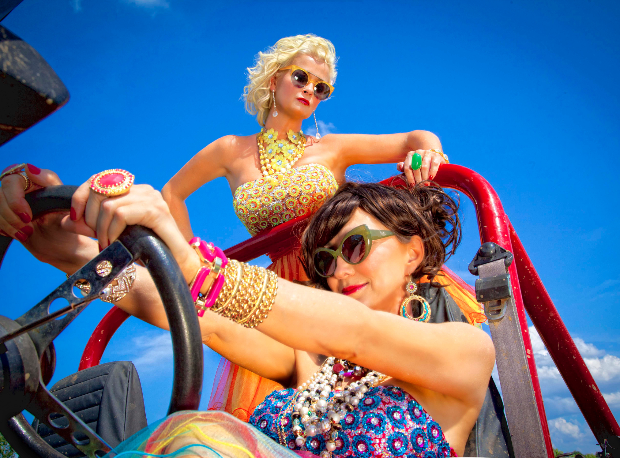 Pam Tillis and Lorrie Morgan in dresses driving side by side